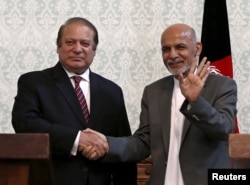 FILE - Afghan President Ashraf Ghani (R) shakes hands with Pakistani Prime Minister Nawaz Sharif after a news conference in Kabul.