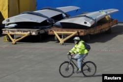 FILE - A worker leaves the Boeing Everett Factory on a bicycle, amid the coronavirus disease (COVID-19) outbreak, in Everett, Washington, U.S. March 23, 2020. (REUTERS/David Ryder)