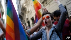 FILE - Participants of a Gay Pride event in support of Lesbian, Gay, Bisexual and Transsexual (LGBT) rights, chant slogans after police dispersed them, in Istanbul, June 28, 2015. 