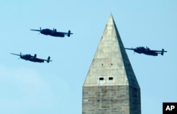 North American B-25 Mitchell bombers fly the Doolittle Raid formation during a flyover near the Washington Monument in Washington, D.C., May 8, 2015.