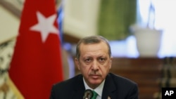FILE - Turkish Prime Minister Recep Tayyip Erdogan attends a news briefing.