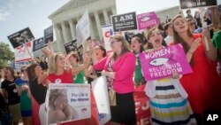 Demonstrators at the Supreme Court representing both sides on the question of whether the government should force employers to provide birth control coverage. The Supreme Court is divided on the issue and suggested lower courts help find a compromise. (AP Photo/Pablo Martinez Monsivais)