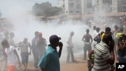 Opposition protesters disperse after tear gas is fired in their midst, in Conakry, Guinea, February 27, 2013 file photo.