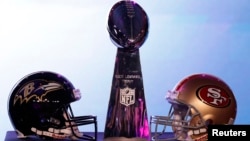 The helmets of the San Francisco 49ers and the Baltimore Ravens sit beside the Vince Lombardi trophy before a press conference ahead of the NFL's Super Bowl XLVII in New Orleans, Louisiana, Feb. 1, 2013. 
