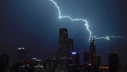 Lightning strikes a skyscraper in Central Business District during a rainstorm in Beijing, Wednesday, Sept. 7, 2016. (AP Photo/Andy Wong)