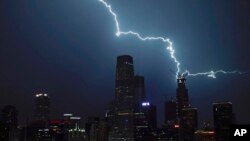 Lightning strikes a skyscraper in Central Business District during a rainstorm in Beijing, Wednesday, Sept. 7, 2016. (AP Photo/Andy Wong)