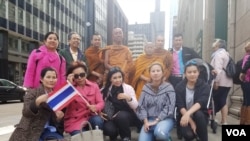 A group of local Thai supporters greet Phra Sutham Nateetong, the monk who is walking for peace across America at the end-point of the walk in Chicago downtown area at 5 pm June 3, 2019.