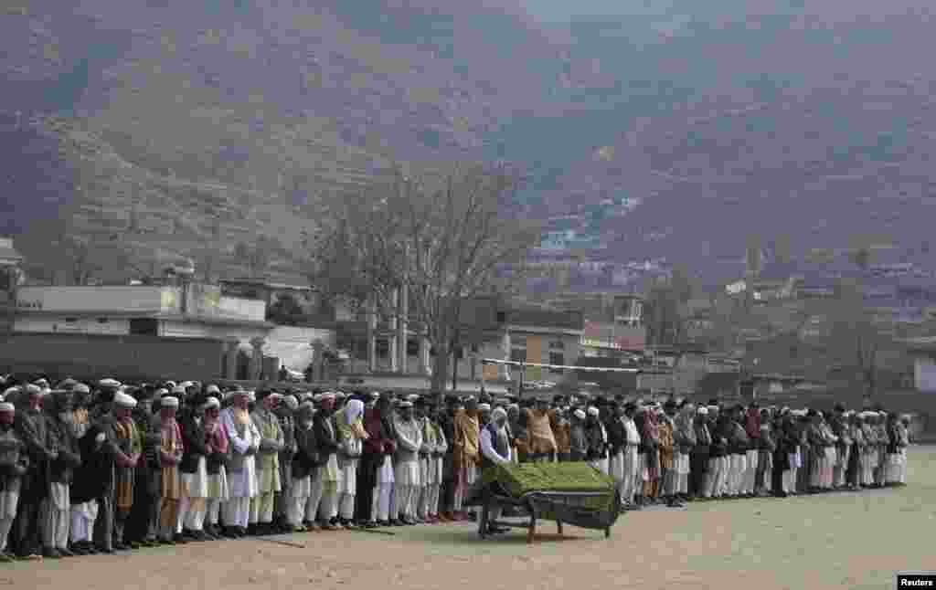People attend funeral prayers for a victim who was killed by a bomb blast, in Mingora, Swat valley, Pakistan, January 11, 2013.