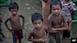 FILE - Rohingya children gather at the Dar Paing camp for Muslim refugees, north of Sittwe, western Rakhine state, Myanmar.