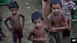 FILE - Rohingya children gather at the Dar Paing camp for Muslim refugees, north of Sittwe, western Rakhine state, Myanmar.