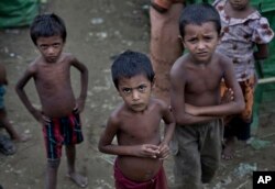 FILE - Rohingya children gather at the Dar Paing camp for Muslim refugees, north of Sittwe, western Rakhine state, Myanmar.