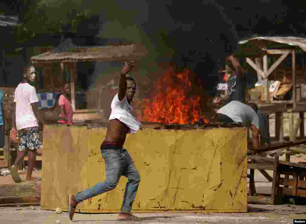 People protest after causing damage to a half-built temporary hospital for treating patients with coronavirus disease (COVID-19). The protesters say it sits is too close to a local community, in Yopougon, Abidjan, Ivory Coast.