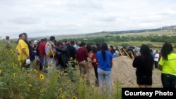 Mourners attend the burial of a 19-year-old Oglala Lakota girl on Pine Ridge Reservation, South Dakota, Aug. 17, 2015. (Photo courtesy of Keith Janis) 