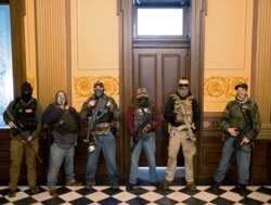 FILE - Pete Musico (R) who was charged October 8, 2020 for his involvement in a plot to kidnap the Michigan governor, stands in front of the Governors office after protesters occupied the state capitol building during a vote to approve the extension of Go