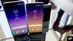 The Samsung Galaxy S8, right, and S8 Plus appear on display after a news conference, Wednesday, March 29, 2017, in New York. The Galaxy S8 features a larger display than its predecessor, the Galaxy S7, and sports a voice assistant intended to rival Siri and Google Assistant. (AP Photo/Mary Altaffer)