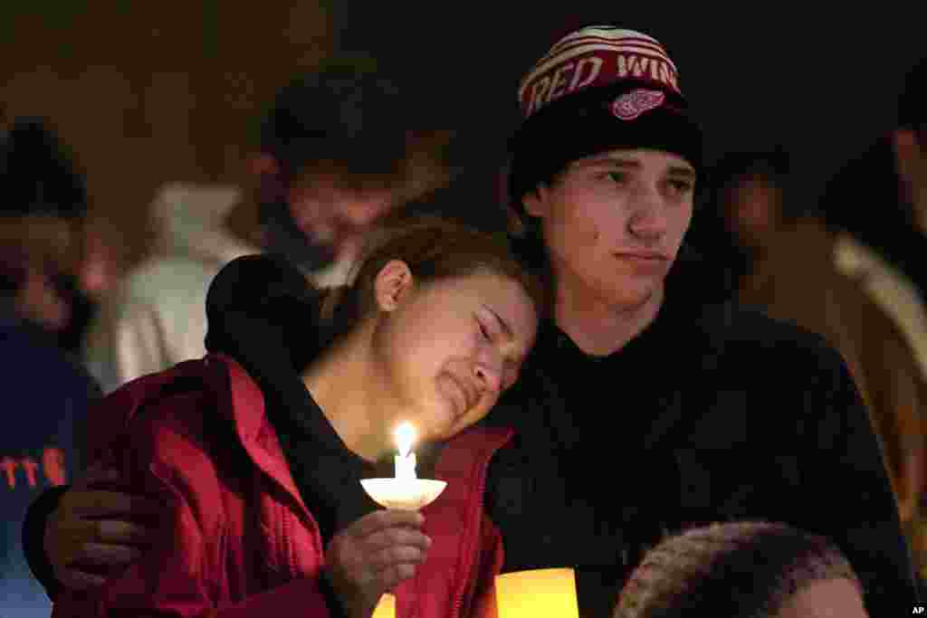 People attending a vigil embrace at LakePoint Community Church in Oxford, Michigan, Nov. 30, 2021.&nbsp;Authorities say a 15-year-old sophomore opened fire at Oxford High School, killing several students and wounding multiple other people, including a teacher.&nbsp;