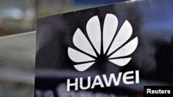 A Huawei logo is seen above the company's exhibition pavilion during the CommunicAsia information and communications technology trade show in Singapore on June 19, 2012.