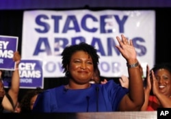 FILE - Democratic candidate for Georgia Governor Stacey Abrams waves to supporters after speaking at an election-night watch party in Atlanta, May 22, 2018.