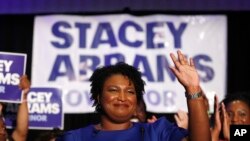 FILE - Democratic candidate for Georgia Governor Stacey Abrams waves to supporters after speaking at an election-night watch party Tuesday, May 22, 2018, in Atlanta. 