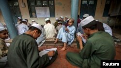 FILE - Pakistani religious students attend a lesson at Darul Uloom Haqqania, an Islamic seminary in Akora Khattak, Khyber Pakhtunkhwa province, Sept. 14, 2013. 