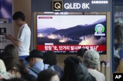 FILE - People watch a TV showing file footage of North Korea's missile launch during a news program at the Seoul Railway Station in Seoul, South Korea, May 4, 2019. North Korea on Saturday fired several unidentified short-range projectiles into the sea.