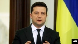 FILE - Ukrainian President Volodymyr Zelenskiy speaks during a joint statement with Croatian Prime Minister Andrej Plenkovic in Kyiv, Dec. 8, 2021.