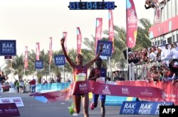 Ababel Yeshaneh crosses the finish line of RAK Half Marathon and breaks the half marathon world record on February 21, 2020 in United Arab emirate of Ras Al Khaimah. (Photo by GIUSEPPE CACACE / AFP)