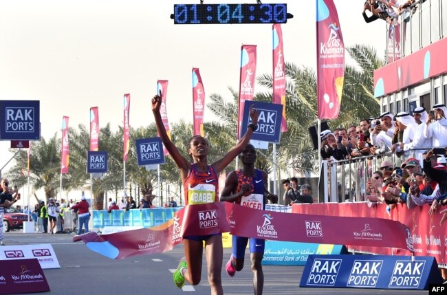 Ababel Yeshaneh crosses the finish line of RAK Half Marathon and breaks the half marathon world record on February 21, 2020 in United Arab emirate of Ras Al Khaimah. (Photo by GIUSEPPE CACACE / AFP)