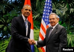 FILE - U.S. President Barack Obama and Cuba's President Raul Castro shake hands during their first meeting on the second day of Obama's visit to Cuba, in Havana, March 21, 2016.