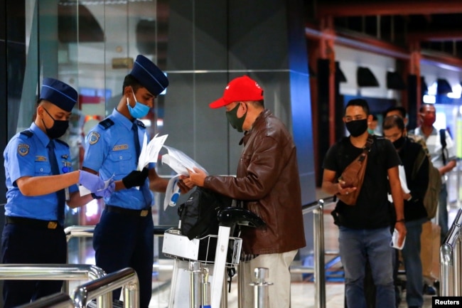 Para calon penumpang antre untuk pemeriksaan dokumen sebelum menaiki pesawat di Bandara Soekarno-Hatta di tengah pandemi virus corona (Covid-19) di Jakarta, 21 Mei 2020. (Foto: Reuters)