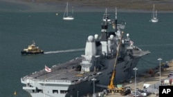 British aircraft carrier HMS Ark Royal lies alongside a quay at the navy dockyard in Portsmouth, England, 19 Oct 2010