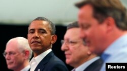 U.S. President Barack Obama glances at Britain's Prime Minister David Cameron (R) during a news conference with European Council President Herman Van Rompuy (L) and European Commission President Jose Manuel Barroso at the G8 summit in Enniskillen, Norther