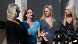 Bonnie Schaan, second from left, discuss her daughter, Cheyeanne Fitzgerald, who was wounded in the shooting at Umpqua Community College, during a news conference outside Mercy Medical Center, Saturday, Oct. 3, 2015, in Roseburg, Oregon.