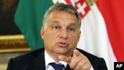 FILE - Hungarian Prime Minister Viktor Orban, shown at a September press conference, has become a divisive figure throughout Europe. 