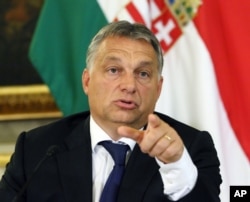 FILE - Hungarian Prime Minister Viktor Orban addresses the media on the occasion of a meeting with Austrian Chancellor Werner Faymann and Vice Chancellor Reinhold Mitterlehner at the Hungarian Embassy in Vienna, Austria, Sept. 25, 2015.