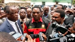 Opposition United Party for National Development president Hakainde Hichilema (C) talks to journalists before being dispersed with supporters athe Woodlands Police Station in Lusaka on March 2, 2016.