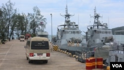 FILE - Buses carrying journalists drive on the jetty mooring warships during a rare media tour of Cambodia’s Ream Naval Base, in Sihanoukville, Cambodia, Friday, July 26, 2019. (Sophat Soeung/VOA Khmer)