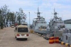 File - Buses carrying journalists drive on the jetty mooring war ships during a rare media tour of Cambodia’s Ream Naval Base, Friday, July 26, 2019. (Sophat Soeung/VOA Khmer)