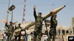 Volunteers of the newly formed "Peace Brigades" participate in a parade in the Shiite stronghold of Sadr City, Baghdad, Iraq, Saturday, June 21, 2014.