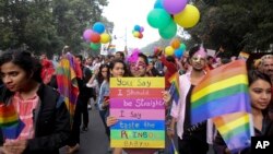 Gay rights activists and their supporters hold colorful balloons and placards as they participate in a gay pride parade in New Delhi, India, Nov. 12, 2017. 