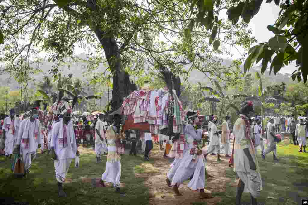 Villagers participate in a religious procession during the traditional Gohain Uliuwa Mela in Mayong village, about 50 kilometers (31 miles) east of Gauhati, India.