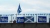 Vandals write on posters that proclaim support for Scotland's Independence near a block of flats in Leith, Edinburgh, Scotland, Sept. 16, 2014. (Marianne Brown/VOA)