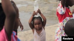 A child holds a bottle of water in Port-au-Prince, Haiti. (File) 