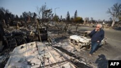 Homeowner Phil Rush reacts as he looks at the remains of his home destroyed by wildfire in Santa Rosa, Calif., Oct. 11, 2017. Rush said he and his wife and dog escaped with only their medication and a bag of dog food when flames overtook their entire neighborhood Oct. 9.