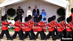FILE - U.S. President Donald Trump and first lady Melania Trump stand with Britain's Queen Elizabeth on the dais in the Quadrangle at Windsor Castle, Windsor, Britain July 13, 2018.