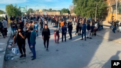 FILE - Protesters gather outside the Green Zone government areas in Baghdad, Dec. 3, 2021. demonstrating against the final results of Iraq's parliamentary elections. 