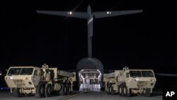 In this photo provided by U.S. Forces Korea, trucks carrying U.S. missile launchers and other equipment needed to set up the Terminal High Altitude Area Defense (THAAD) missile defense system arrive at the Osan air base in Pyeongtaek, South Korea, March 6, 2017.