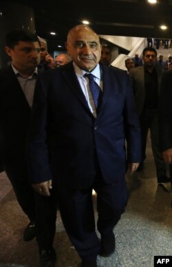 Iraqi Prime Minister Adel Abdul Mahdi walks out of the Parliament in Baghdad on Oct. 2, 2018.