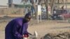 Mallam Muhammadu scavenges a trash dump in the city of Yola, in northeastern Adamawa state, Nigeria, February 14, 2012. He uses the bullhorn to announce his arrival in neighborhoods, where offers to buy unwanted items he can fix and sell.