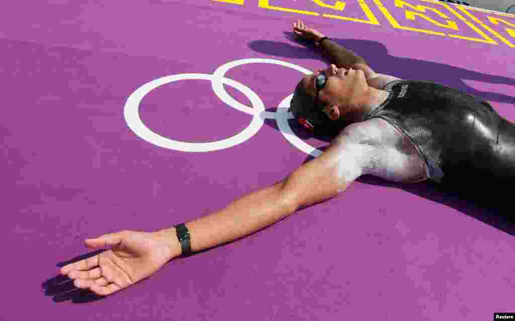 Oussama Mellouli of Tunisia reacts after winning gold in the men's 10km marathon swimming at Hyde Park.